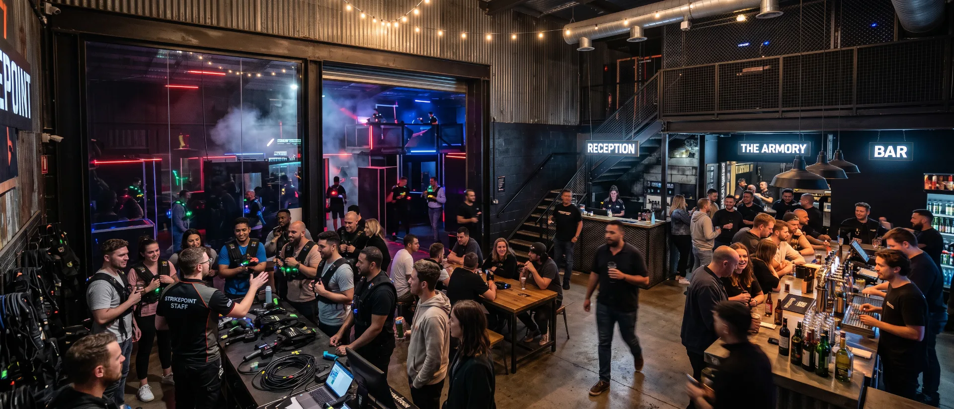 Guests gearing up for laser tag beside the bar at an entertainment center