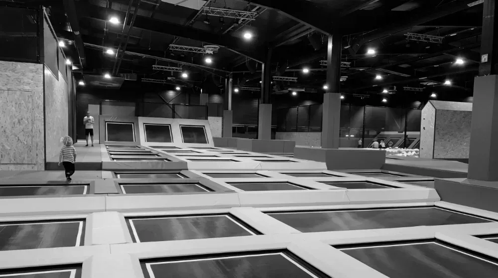 Empty trampoline park on a weekday afternoon — the quiet hours a family entertainment center still pays for