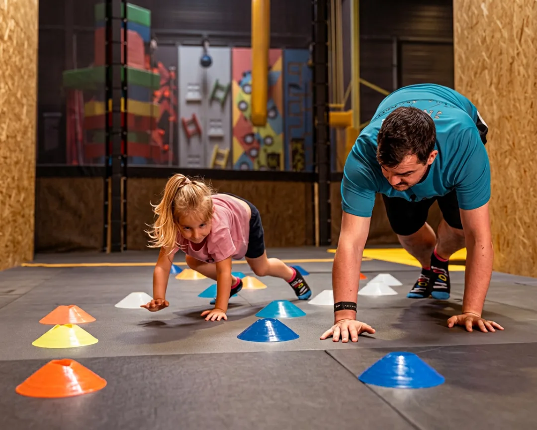 Father and daughter racing through an obstacle course together
